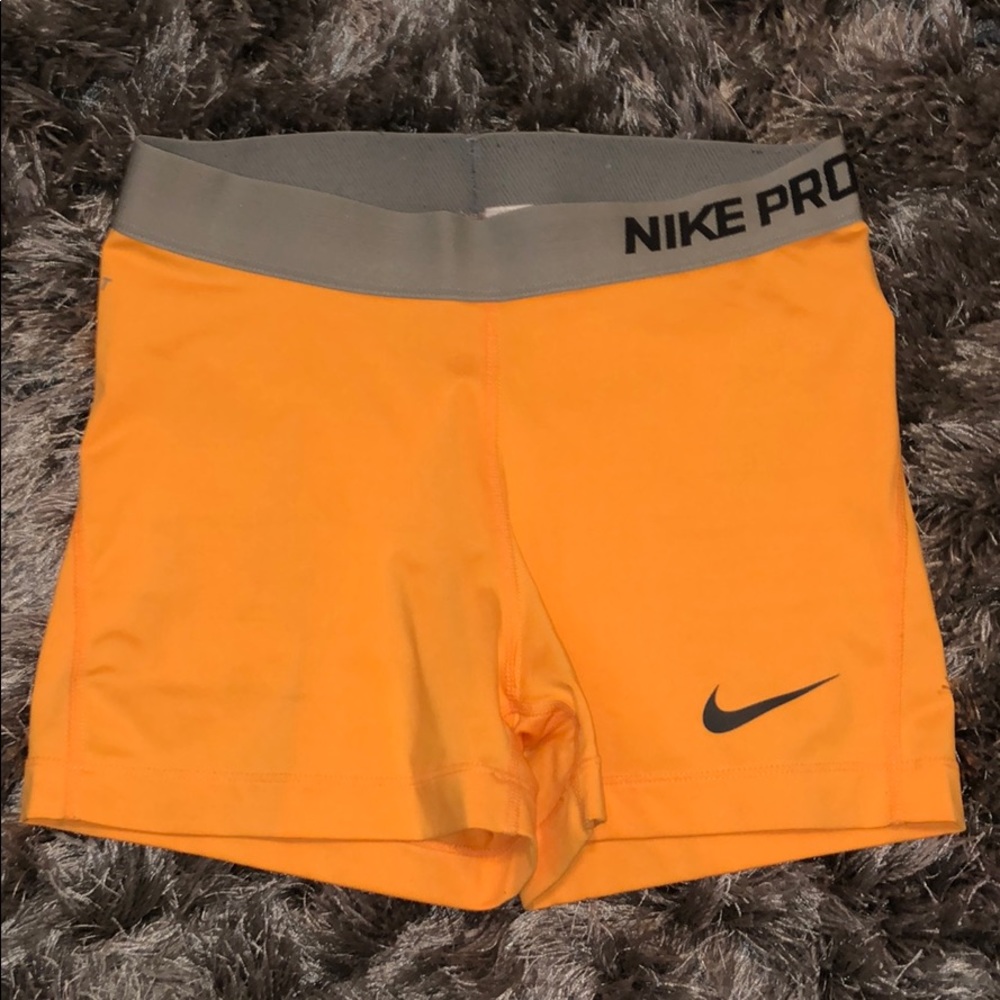 Orange Nike Pros shorts